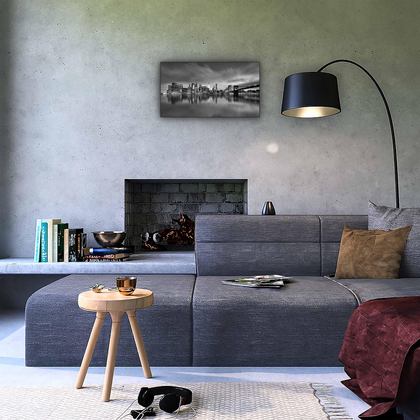 Modern living room with gray sectional sofa, concrete fireplace, and black-and-white cityscape wall art.